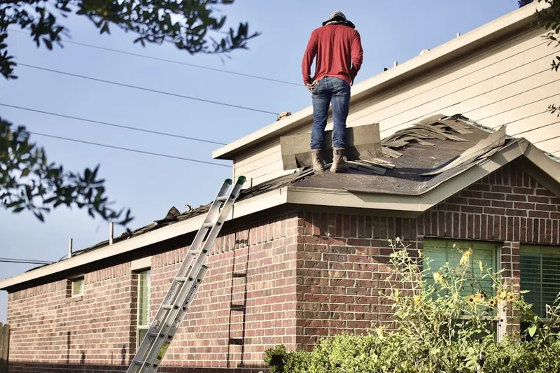 Professional roofer working on a residential roof in North Great River